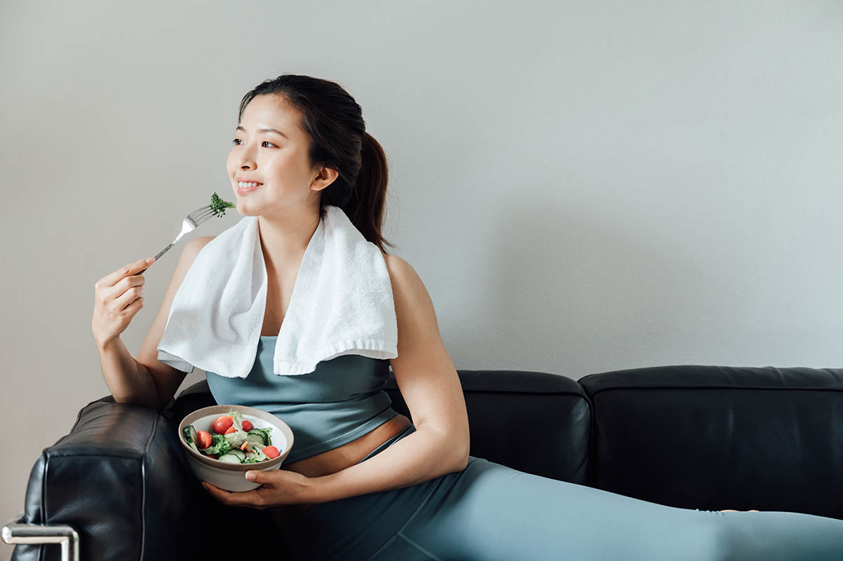 asian woman eating salad