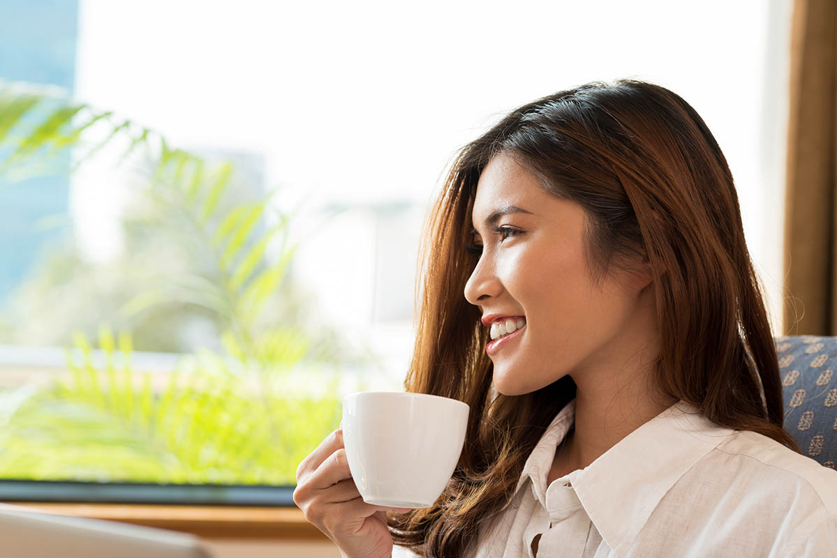asian woman drinking coffee