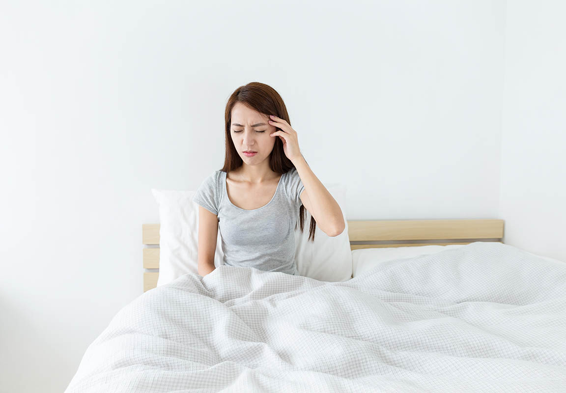 woman suffering from headache due to sleep bruxism woman suffering from headache due to sleep bruxism