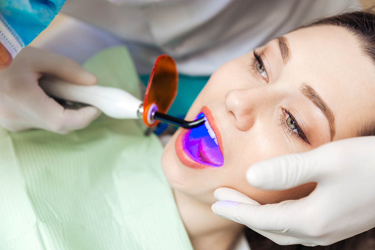 girl during led teeth whitening procedure