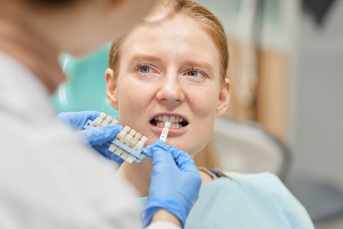 woman at the dentist for choosing dental crown