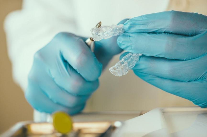 Dentist preparing Invisalign for a patient Dentist preparing Invisalign for a patient