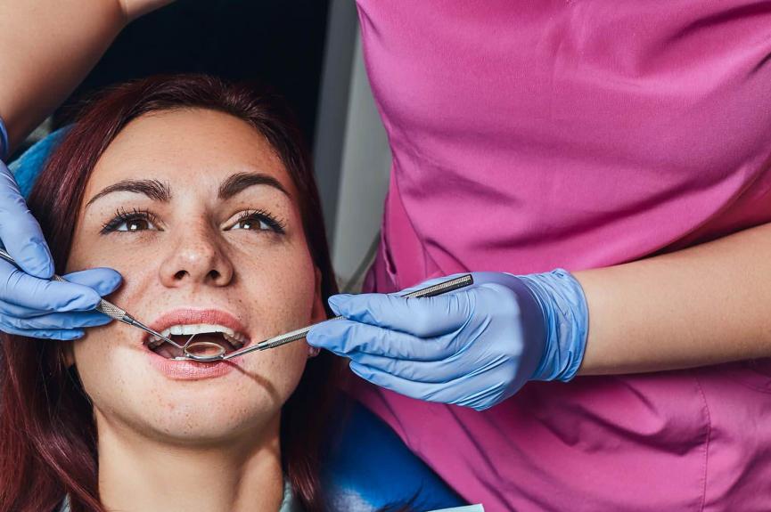 A young woman being examined by a dentist A young woman being examined by a dentist