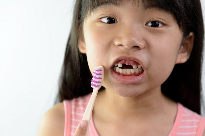 little girl brushing her teeth