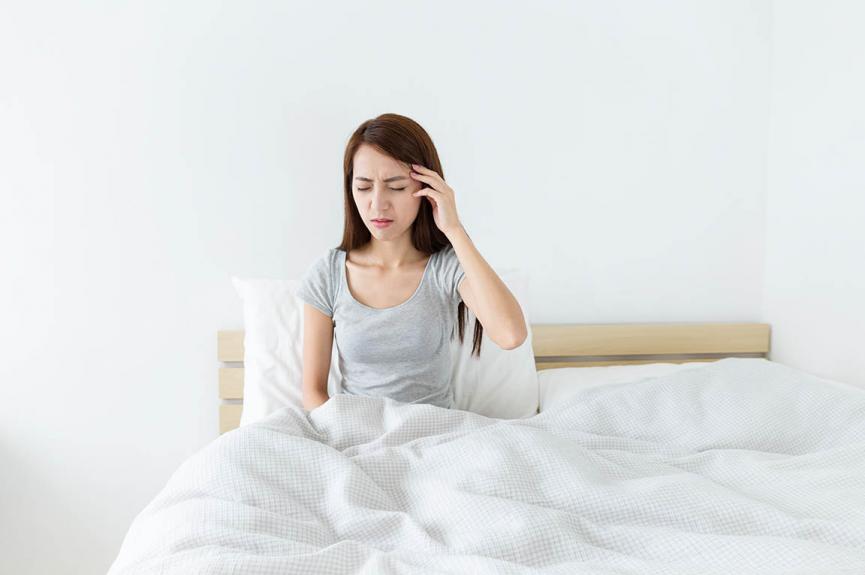 woman suffering from headache due to sleep bruxism woman suffering from headache due to sleep bruxism