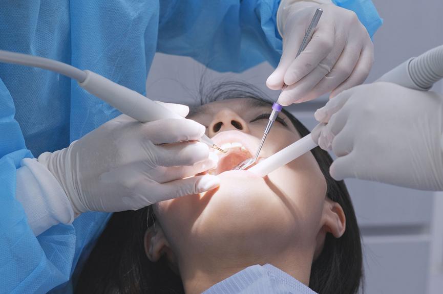 Oral Surgeon Working on patient Oral Surgeon Working on patient