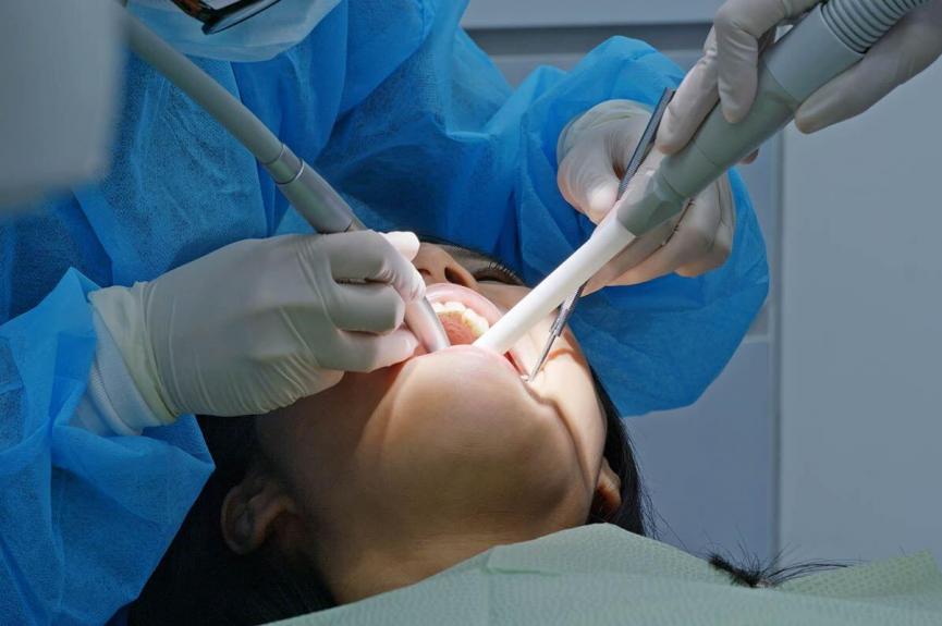 woman undergoing a dental treatment in a dental clinic woman undergoing a dental treatment in a dental clinic