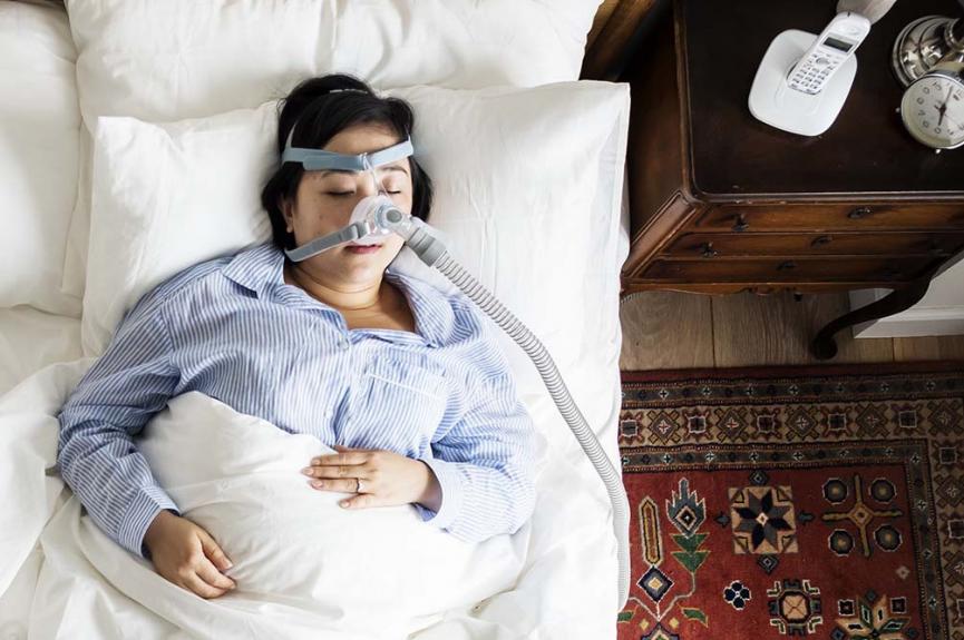 woman sleeping with anti snoring mask for sleep apnea woman sleeping with anti snoring mask for sleep apnea