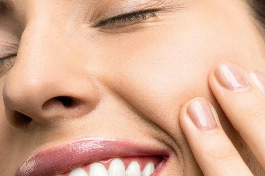 woman smiling showing pronounced canine teeth woman smiling showing pronounced canine teeth