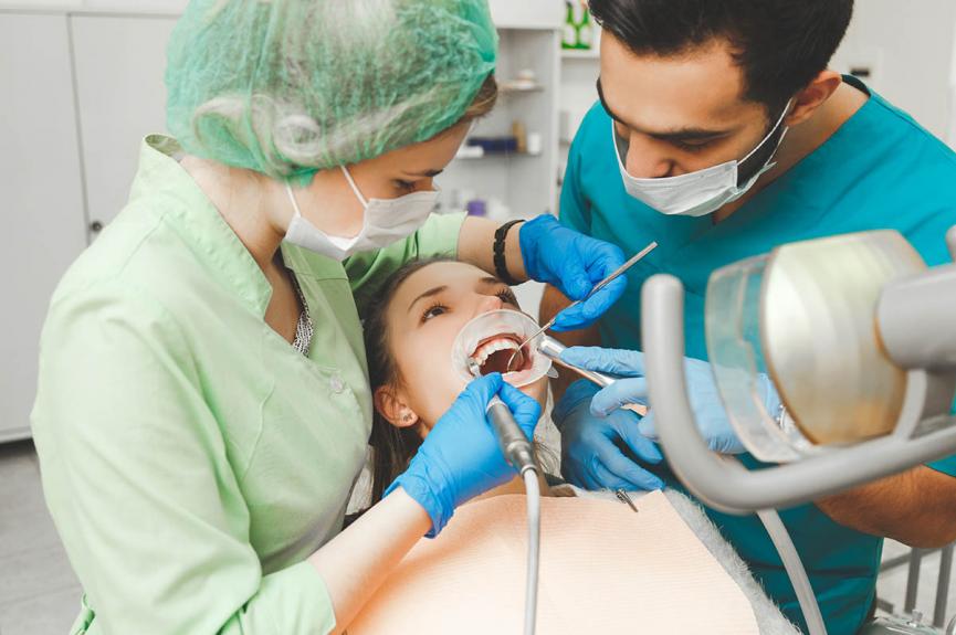 woman undergoing teeth cleaning treatment woman undergoing teeth cleaning treatment