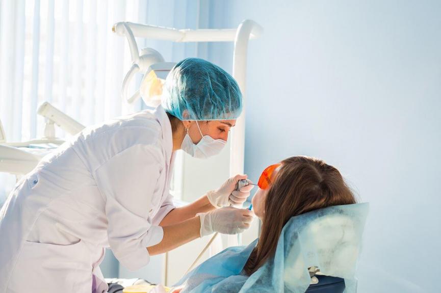 young woman getting her teeth checked young woman getting her teeth checked
