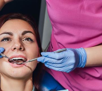 A young woman being examined by a dentist