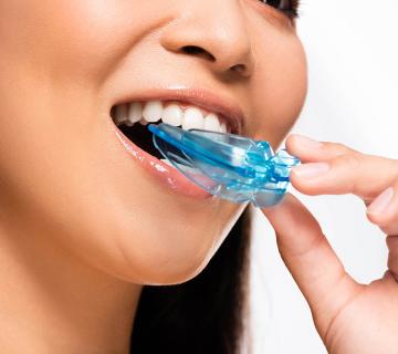 asian woman using mouth guard