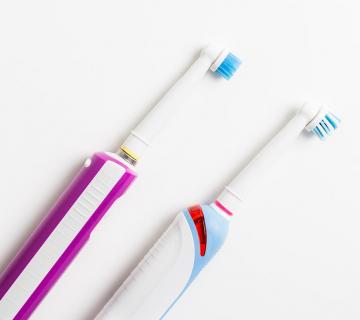 two electric toothbrushes
