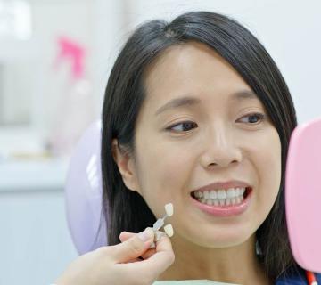 dentist showing veneers to patient