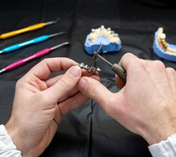 dental technician working on dental dentures