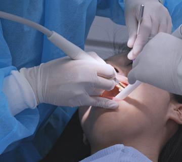 dentist examining woman for gingivitis