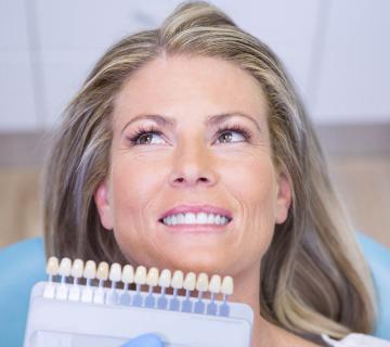 dentist holding teeth whitening equipment