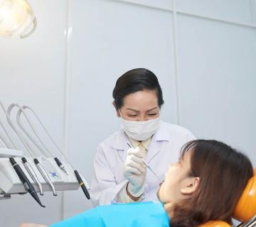 female dentist working with patient