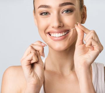 Girl cleaning white teeth