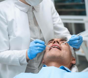 man undergoing tooth decay treatment at the dentist