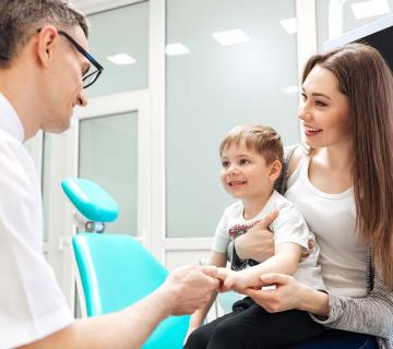 mother and little son at the dentist
