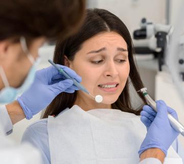 scared and anxious woman at the dentist