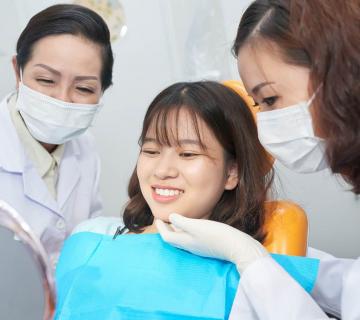 Smiling teenager checking healthy teeth