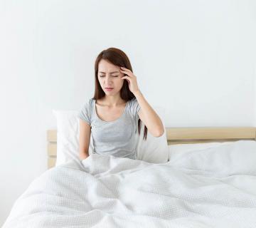 woman suffering from headache due to sleep bruxism