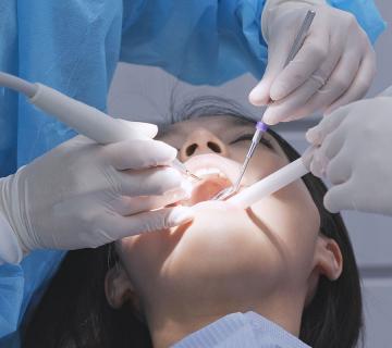 Oral Surgeon Working on patient