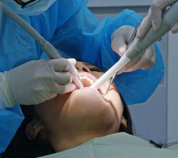 woman undergoing a dental treatment in a dental clinic