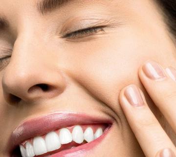 woman smiling showing pronounced canine teeth