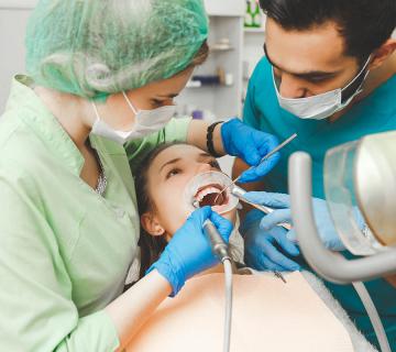 woman undergoing teeth cleaning treatment