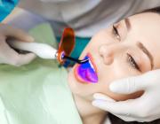 girl during led teeth whitening procedure girl during led teeth whitening procedure