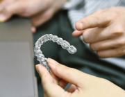 man holding invisalign aligners man holding invisalign aligners