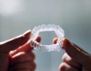 man holding invisalign aligners man holding invisalign aligners