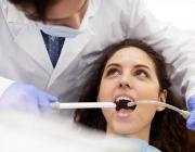 woman undergoing professional dental cleaning woman undergoing professional dental cleaning