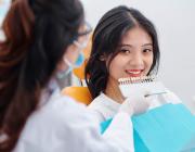 dentist selecting teeth colour for patient teeth whitening dentist selecting teeth colour for patient teeth whitening